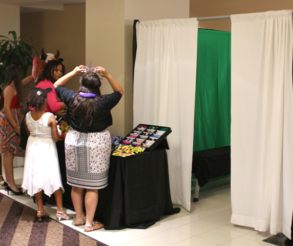 Green screen photo booth with white curtains.
